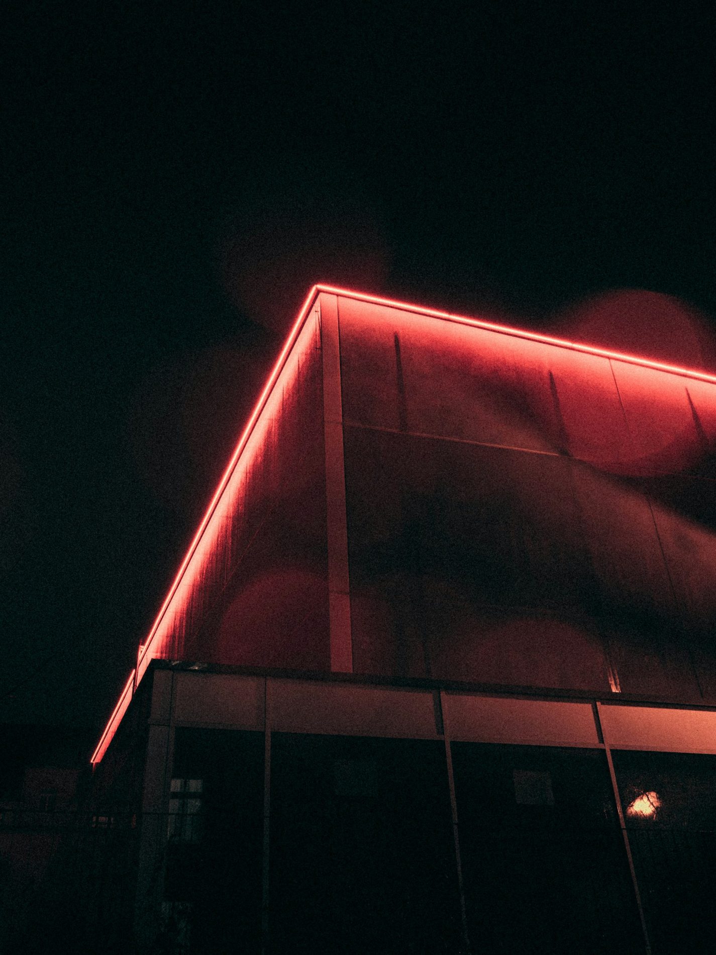 Red LED accent lighting installed along building roof in Sacramento